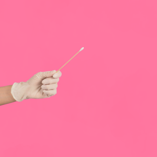 medical-glove-test-vaginal swab-microbiome-testing Medical professional wearing a glove holding a test tube for fertility or microbiome testing.
